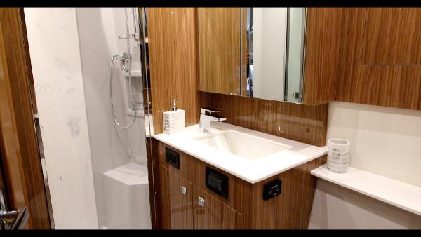Slide: The Image of 2024 Cruisers Yachts 50 Cantius bathroom with modern fixtures and wooden cabinetry. - 44