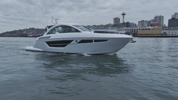 Slide: The Image of 2024 Cruisers Yachts 50 Cantius on water with city skyline background. - 6
