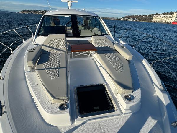 Slide: The Image of 2024 Cruisers Yachts 50 Cantius bow deck with sun loungers and table. - 8