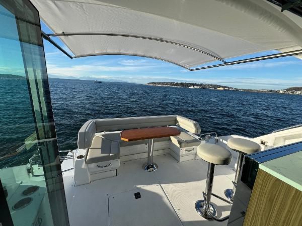 Slide: The Image of 2024 Cruisers Yachts 50 Cantius aft deck with seating and ocean view. - 9