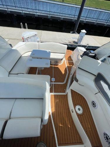 Slide: The Image of 2008 Cruisers Yachts Express with white seating and teak flooring at dock. - 10