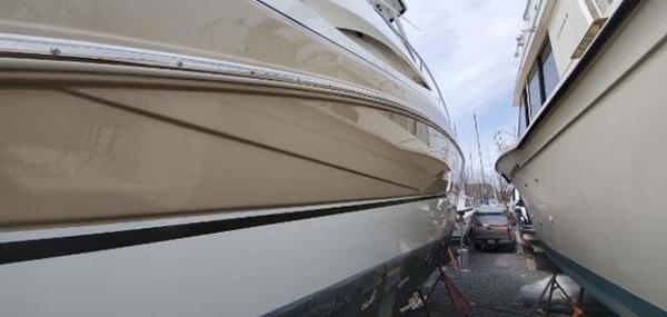 Slide: The Image of 2008 Cruisers Yachts Express boat in a marina, side view. - 12