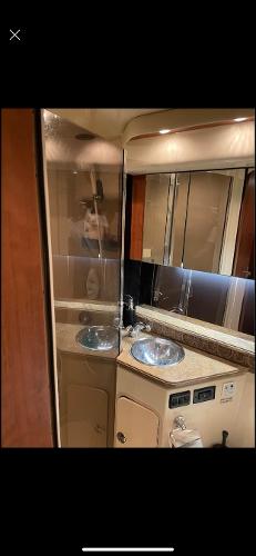 Slide: The Image of 2008 Cruisers Yachts Express bathroom with dual sinks and mirrored cabinets. - 14