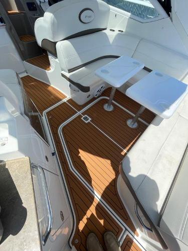 Slide: The Image of 2008 Cruisers Yachts Express interior with white seating and wooden flooring. - 8