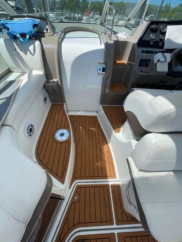 Slide: The Image of 2008 Cruisers Yachts Express cockpit with teak flooring and white seating. - 9