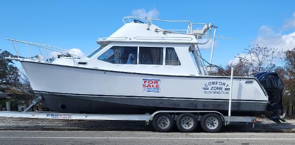 Slide: The Image of 2012 Crusader Boats outboard cruiser on trailer, "For Sale" sign visible. - 1