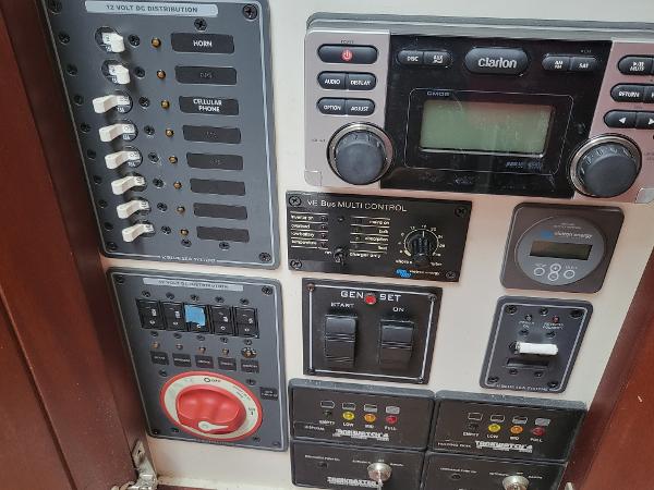 Slide: The Image of Control panel of a 2012 Crusader Boats outboard cruiser with various switches and displays. - 24