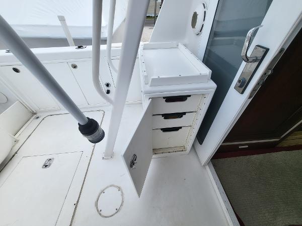 Slide: The Image of 2012 Crusader Boats outboard cruiser interior with open storage compartments and sleek white design. - 31