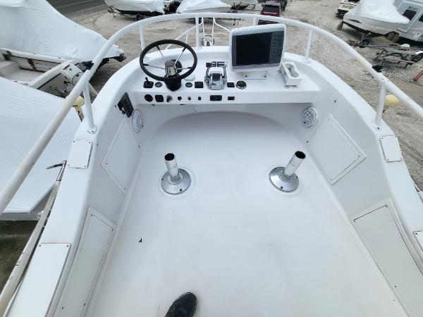 Slide: The Image of 2012 Crusader Boats outboard cruiser cockpit with steering wheel and navigation equipment. - 42