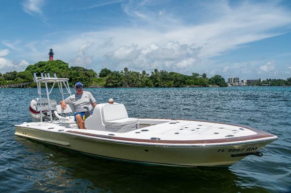 Slide: The Image of Man on 2017 Custom Envi Redfisher boat in scenic waters with lighthouse background. - 0