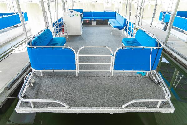 Slide: The Image of 2000 Custom Lake Wind 25 x 10 Pontoon with blue seating and spacious deck. - 10