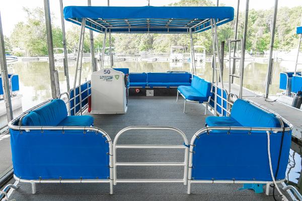 Slide: The Image of 2000 Custom Lake Wind 25 x 10 Pontoon with blue seating and canopy. - 11