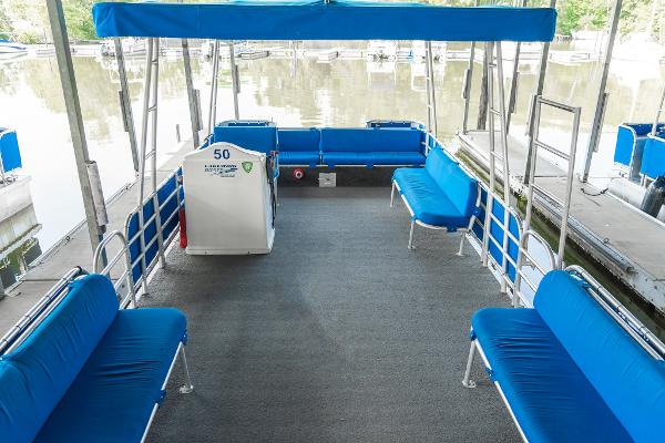 Slide: The Image of Interior of a 2000 Custom Lake Wind 25 x 10 Pontoon with blue seating. - 12
