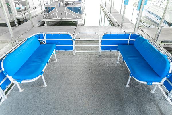 Slide: The Image of 2000 Custom Lake Wind 25 x 10 Pontoon with blue seating and spacious deck. - 13