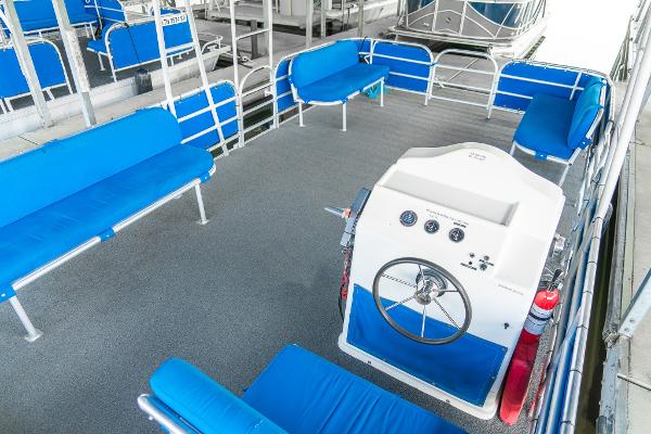 Slide: The Image of Interior of a 2000 Custom Lake Wind 25 x 10 Pontoon boat with blue seating. - 19