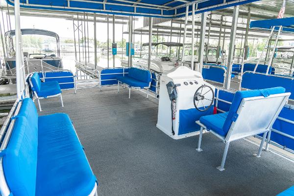 Slide: The Image of Custom Lake Wind 25 x 10 Pontoon 2000 model with blue seating and steering console. - 22