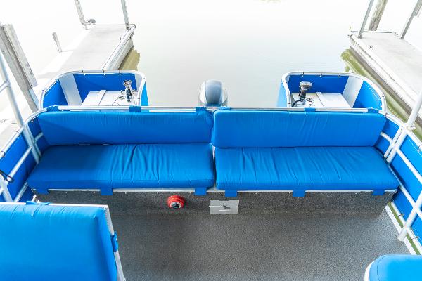 Slide: The Image of Custom 2000 Lake Wind 25 x 10 Pontoon with blue seating and outboard motor. - 23