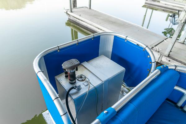 Slide: The Image of 2000 Custom Lake Wind 25 x 10 Pontoon boat with blue seating and fuel tank. - 26