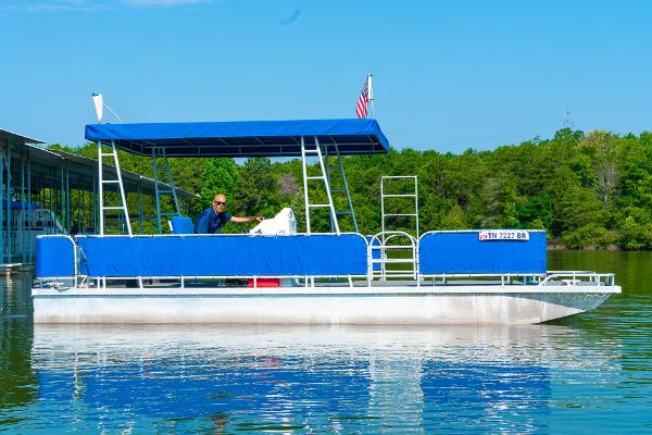 Slide: The Image of Custom 2000 Lake Wind 25 x 10 Pontoon boat on a serene lake. - 3