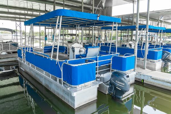 Slide: The Image of 2000 Custom Lake Wind 25 x 10 Pontoon boat with blue canopy and Yamaha outboard motor. - 5