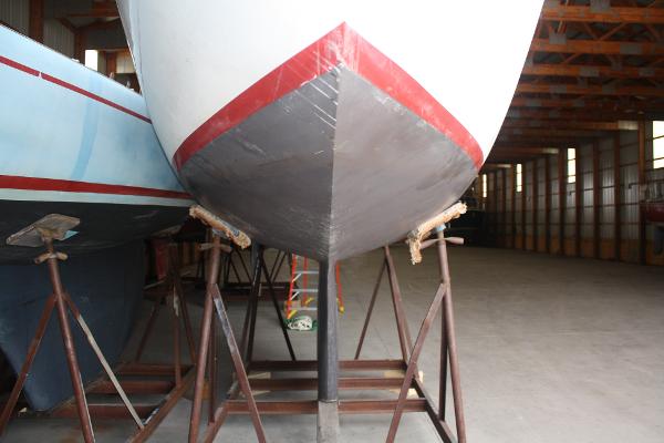 Slide: The Image of 1934 Custom Northern Michigan NM boat hull in storage on stands. - 10