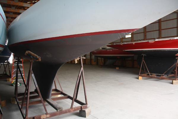 Slide: The Image of 1934 Custom Northern Michigan NM sailboats in storage, showcasing hull and keel design. - 12