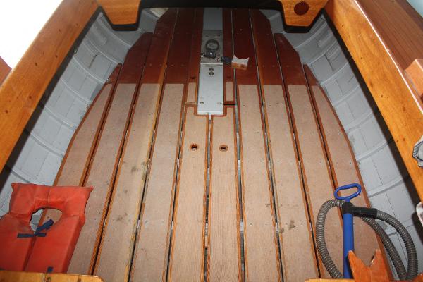 Slide: The Image of 1934 Custom Northern Michigan NM boat interior with wooden floor and safety equipment. - 17