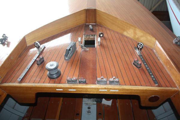 Slide: The Image of 1934 Custom Northern Michigan NM sailboat deck with wooden finish and rigging hardware. - 18