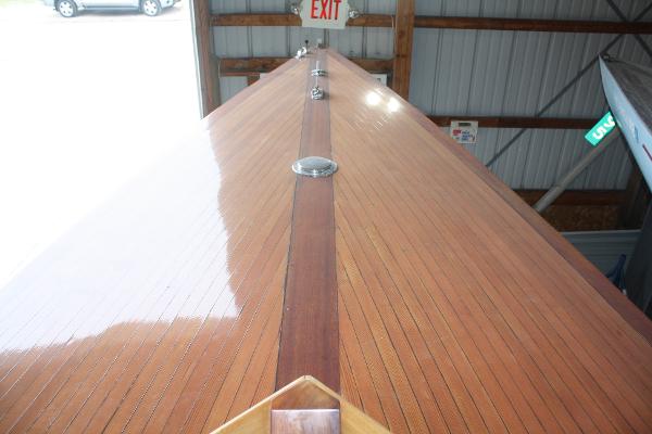 Slide: The Image of 1934 Custom Northern Michigan NM boat with polished wooden deck in storage. - 19