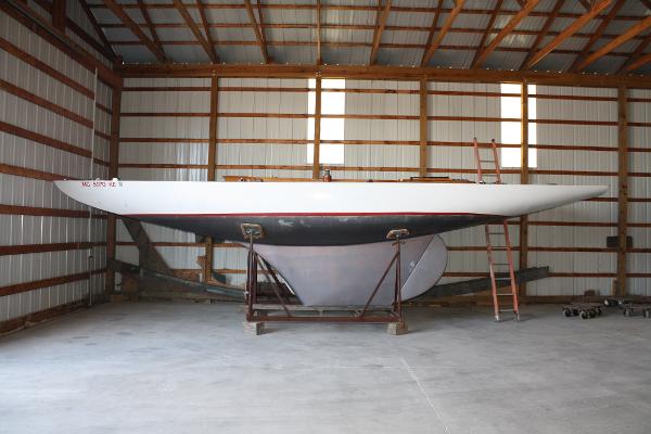 Slide: The Image of 1934 Custom Northern Michigan NM sailboat stored in a wooden barn. - 3
