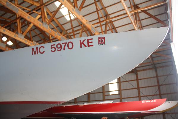 Slide: The Image of 1934 Custom Northern Michigan NM boat with registration number MC 5970 KE in a wooden boathouse. - 9