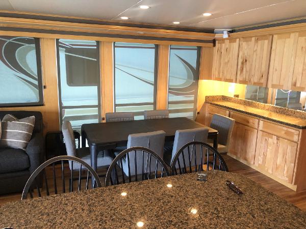 Slide: The Image of Modern RV interior with granite countertops, dining area, and wooden cabinetry, Custom The Entourage Shares 2005. - 24