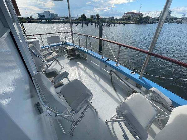 Slide: The Image of Deck of 1987 Custom Trawler Biloxi Lugger with chairs overlooking marina. - 18