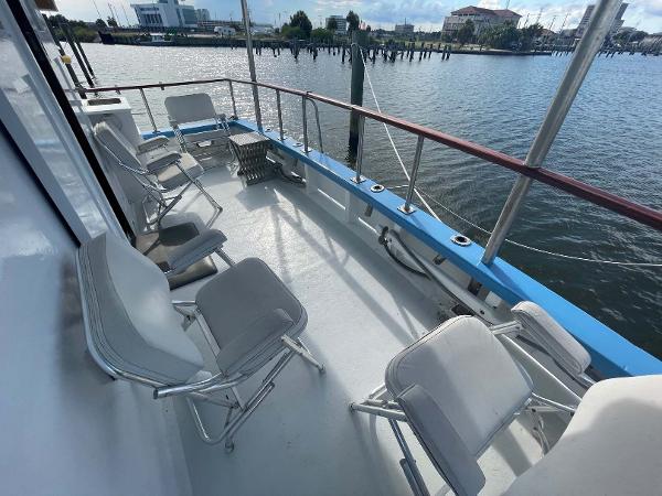 Slide: The Image of 1987 Custom Trawler Biloxi Lugger deck with chairs overlooking marina. - 19