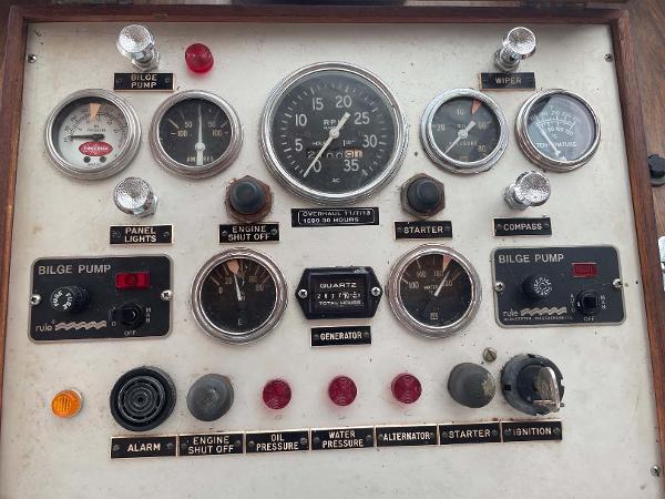 Slide: The Image of Control panel of a 1987 Custom Trawler Biloxi Lugger with gauges and switches. - 25