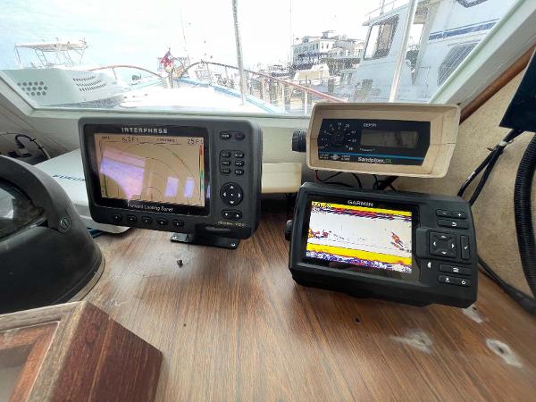 Slide: The Image of Navigation equipment on 1987 Custom Trawler Biloxi Lugger, featuring radar and GPS displays. - 27