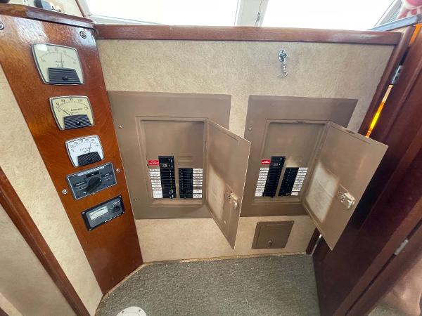 Slide: The Image of Electrical panel on 1987 Custom Trawler Biloxi Lugger, featuring open circuit breaker boxes. - 28