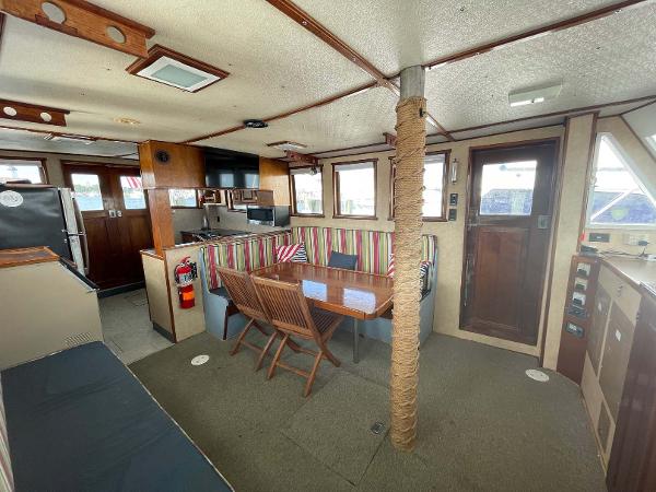 Slide: The Image of Interior of 1987 Custom Trawler Biloxi Lugger with dining area and nautical decor. - 31