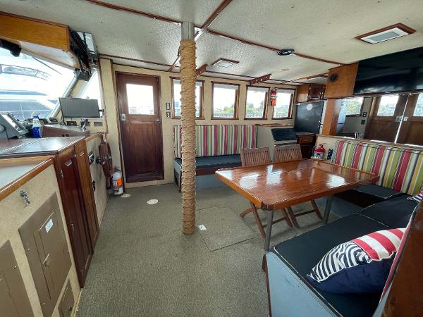 Slide: The Image of Interior of 1987 Custom Trawler Biloxi Lugger with seating, table, and nautical decor. - 33