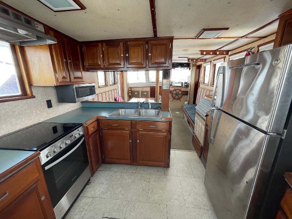 Slide: The Image of Interior of 1987 Custom Trawler Biloxi Lugger with modern kitchen and stainless steel appliances. - 38