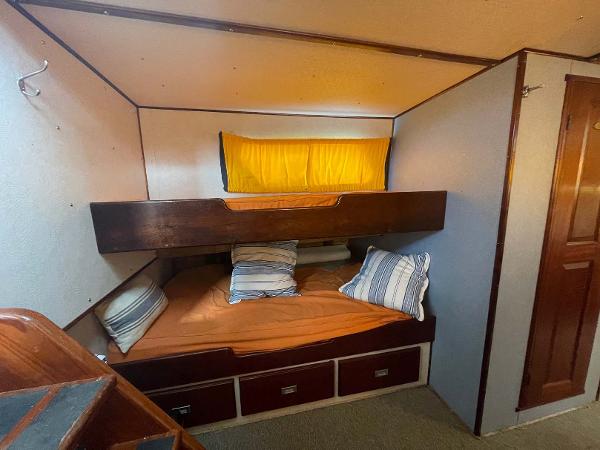 Slide: The Image of Cozy cabin interior of 1987 Custom Trawler Biloxi Lugger with bunk beds and striped pillows. - 42