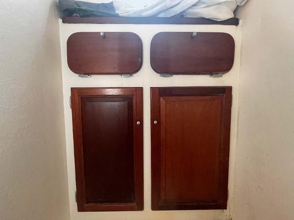 Slide: The Image of Wooden cabinets inside a 1987 Custom Trawler Biloxi Lugger boat. - 45