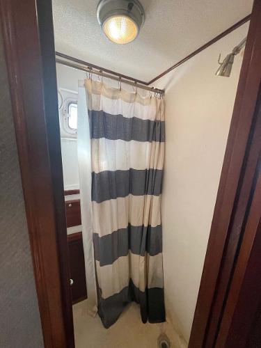 Slide: The Image of Shower area in 1987 Custom Trawler Biloxi Lugger with striped curtain. - 46