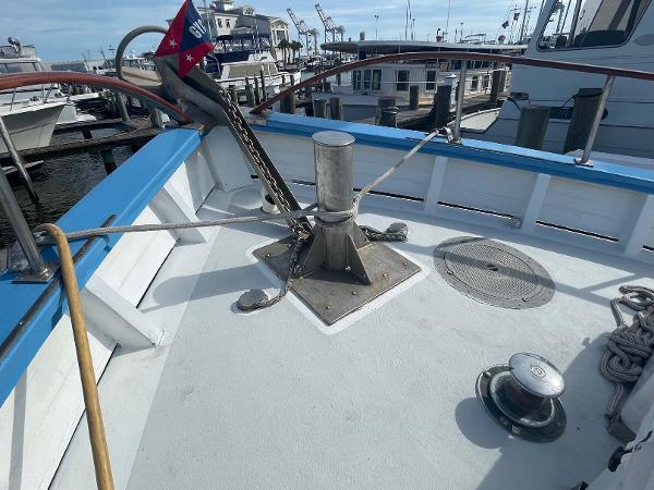 Slide: The Image of Bow of 1987 Custom Trawler Biloxi Lugger with anchor and ropes at dock. - 5