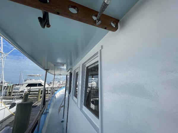 Slide: The Image of Side view of 1987 Custom Trawler Biloxi Lugger docked at marina. - 6