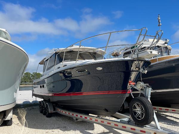 Slide: The Image of 2016 Cutwater 30 Sedan LE boat on trailer under blue sky. - 1