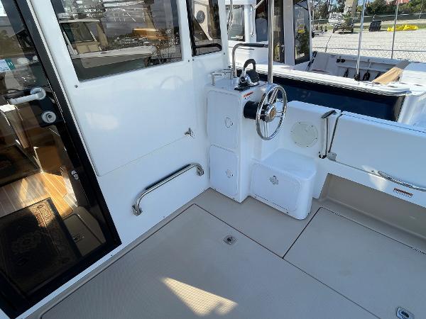 Slide: The Image of 2016 Cutwater 30 Sedan LE boat cockpit with steering wheel and seating area. - 10