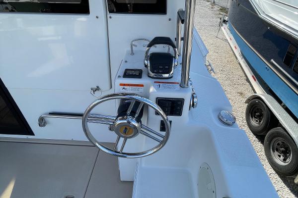 Slide: The Image of Steering wheel and controls of a 2016 Cutwater 30 Sedan LE boat. - 11