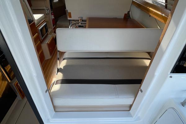 Slide: The Image of Interior of 2016 Cutwater 30 Sedan LE, featuring seating and kitchenette. - 15