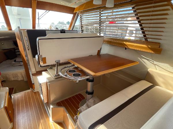 Slide: The Image of Interior of 2016 Cutwater 30 Sedan LE with wooden table and seating. - 17